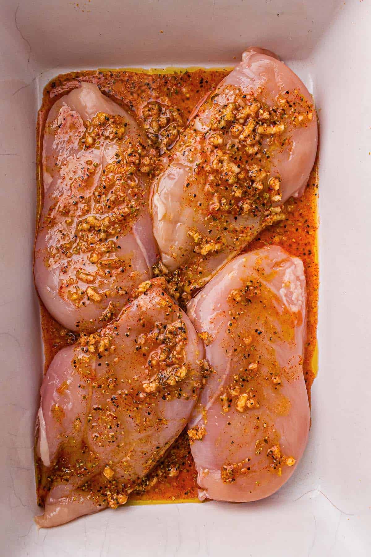 Chicken breasts marinating in lemon garlic mixture.