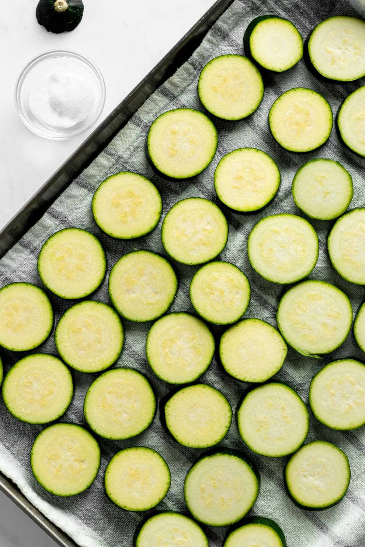 slices of zucchini on baking sheet.