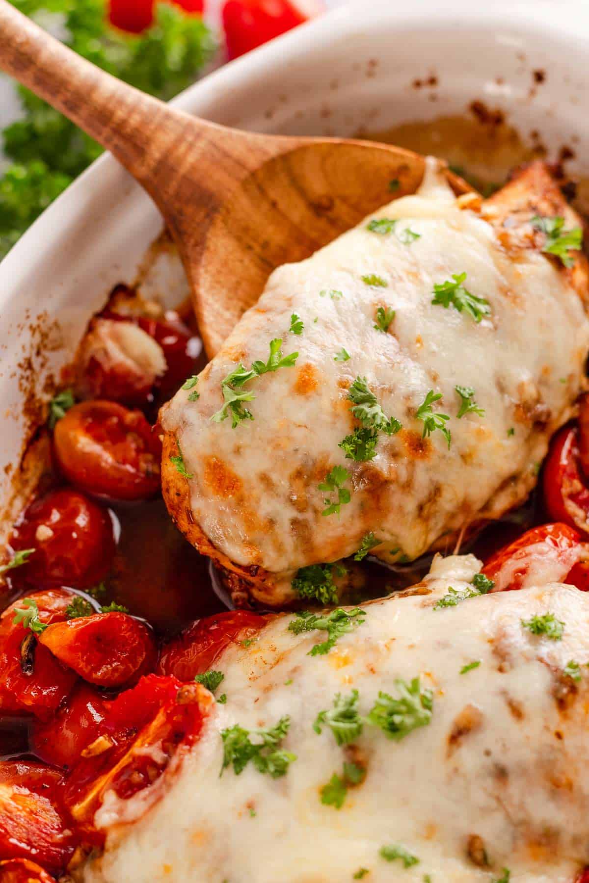 Chicken breast coated in balsamic marinade and baked with cherry tomatoes and mozzarella cheese.