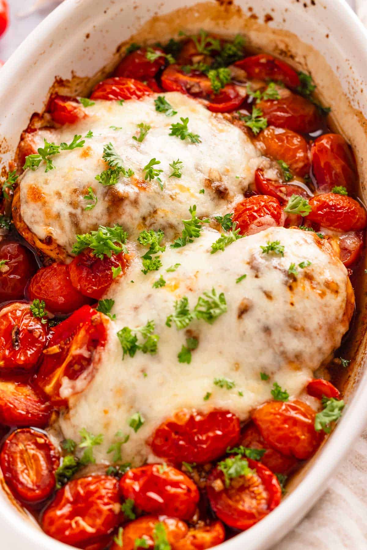 Chicken breast coated in balsamic marinade and baked with cherry tomatoes and mozzarella cheese.