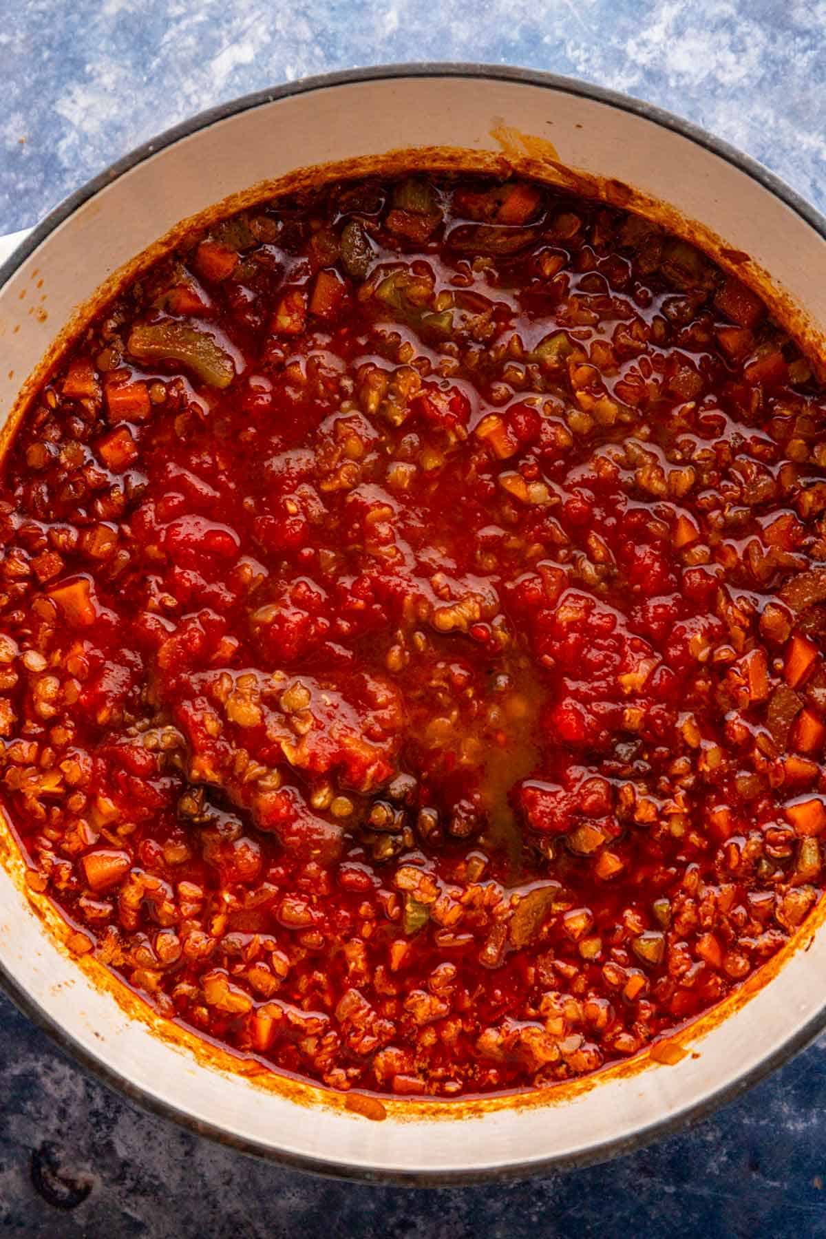diced tomatoes added to lentil soup pot.