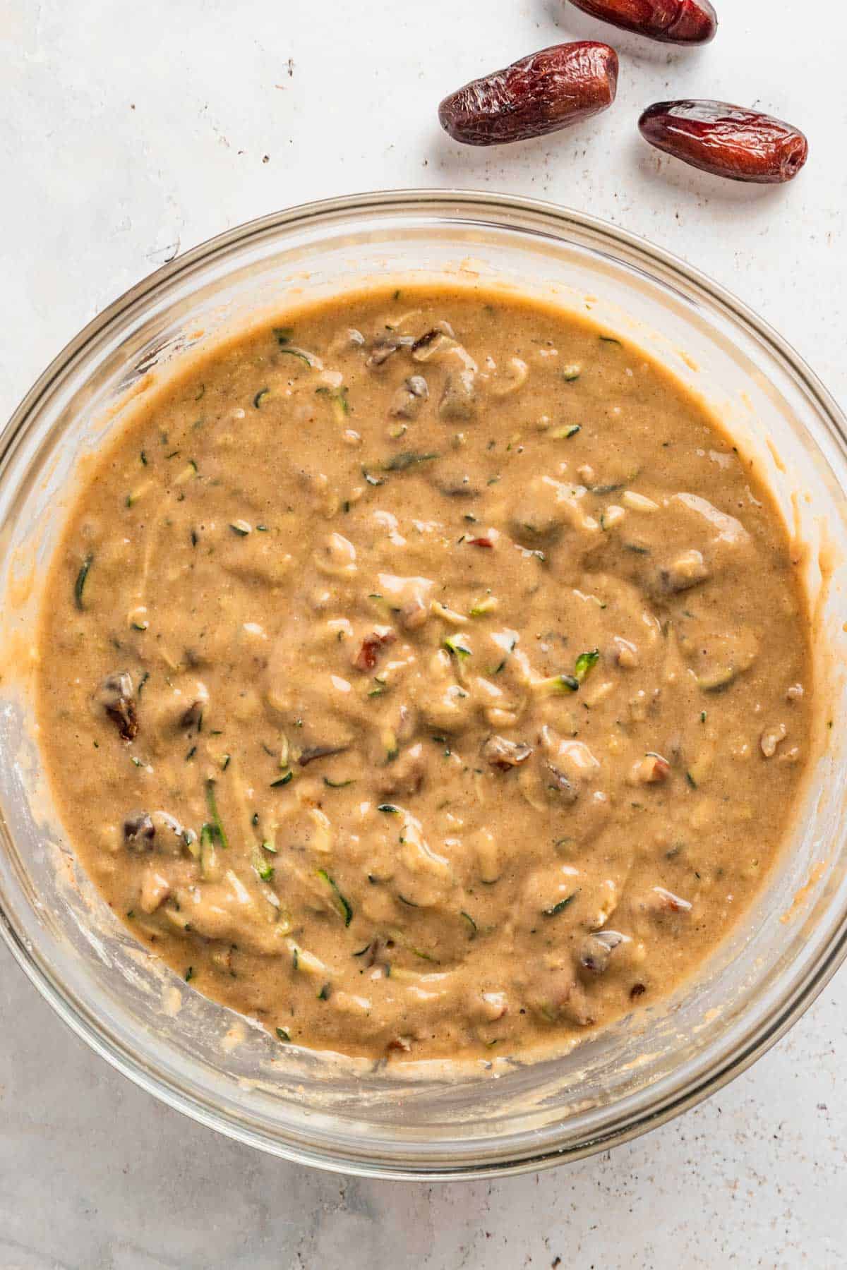 Zucchini nut bread mixture in a bowl.