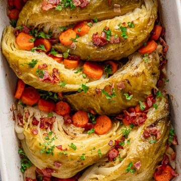 braised cabbage recipe with vegetables in casserole dish.