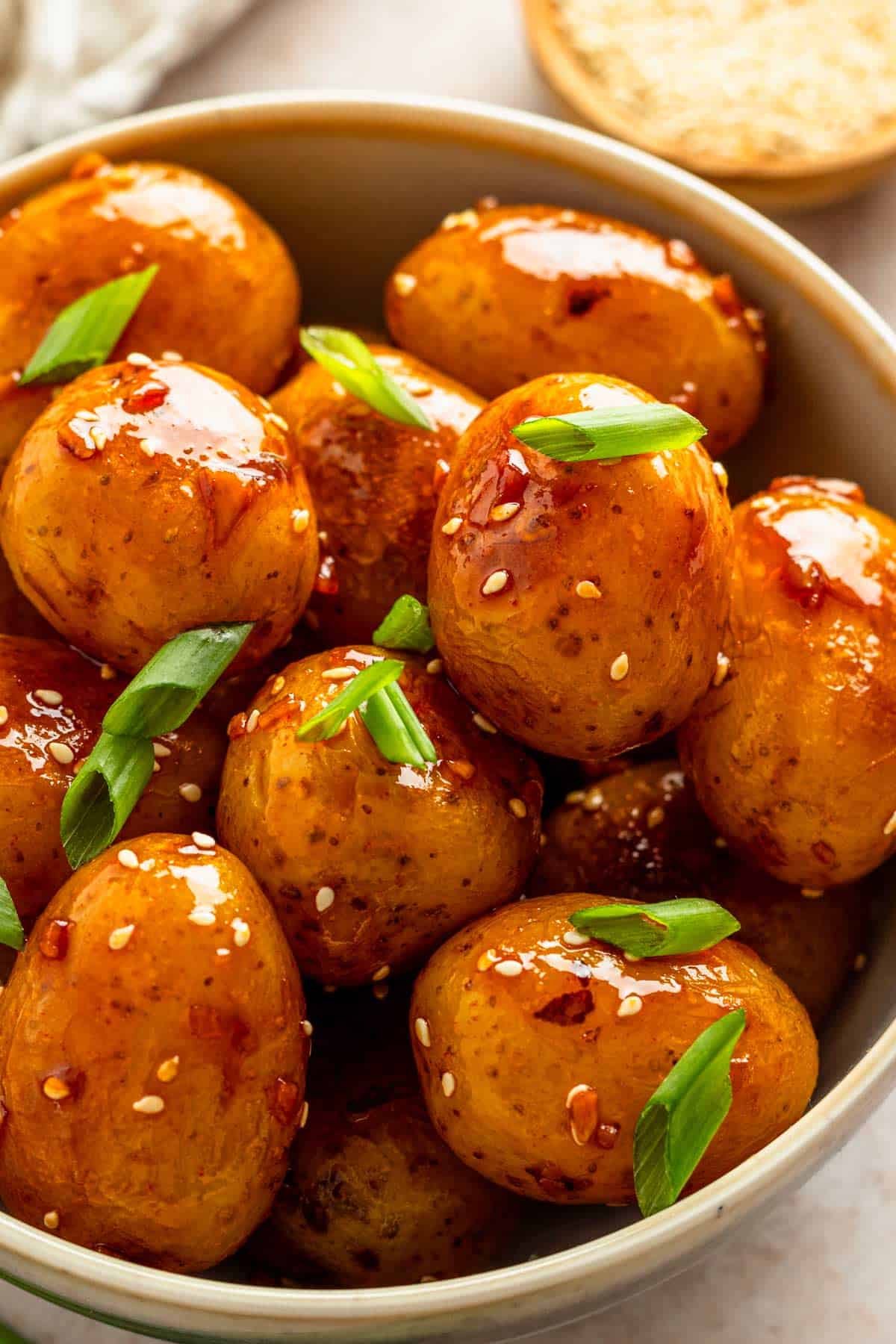 baby potatoes with dark sauce in skillet.
