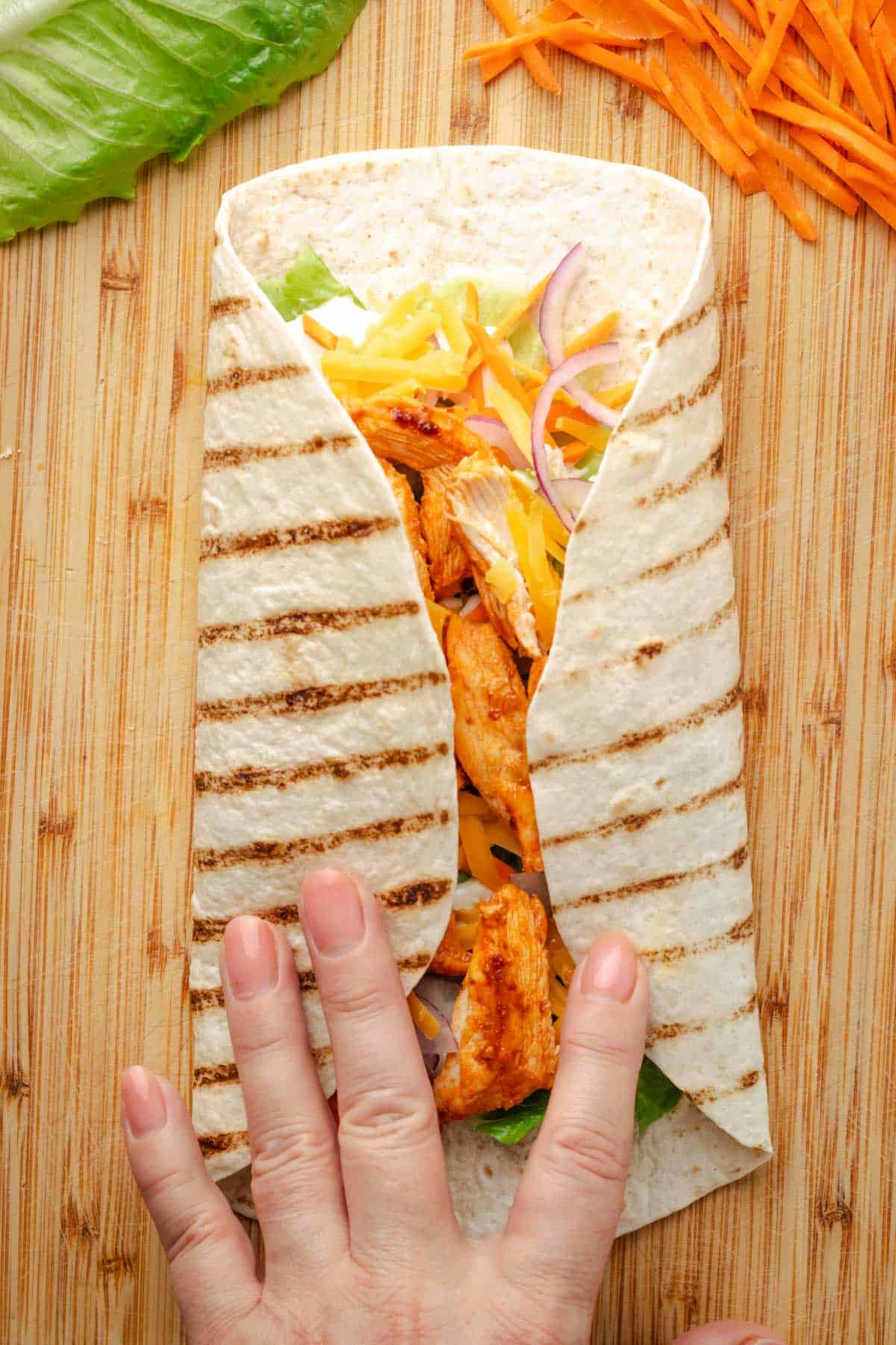 Folding buffalo chicken wrap.