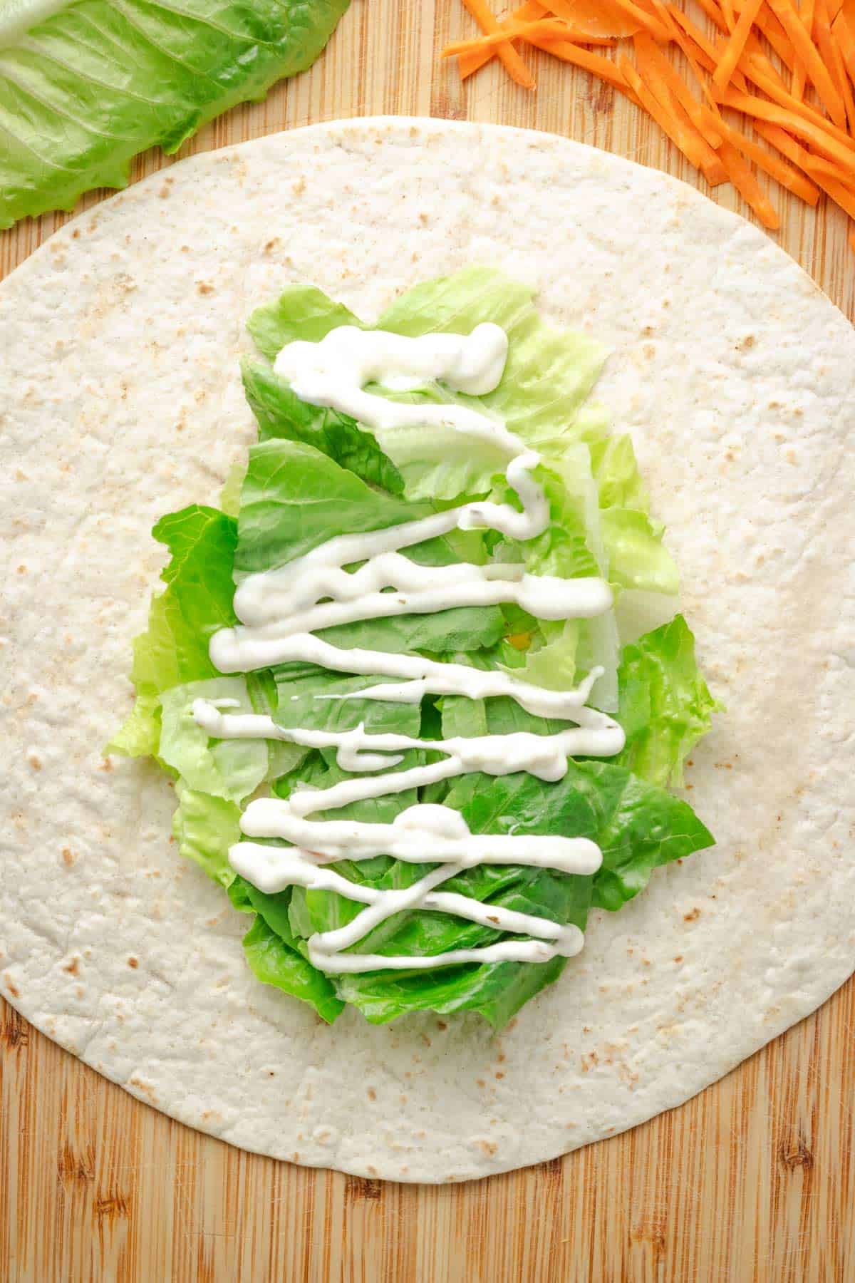 Lettuce on top of tortilla.