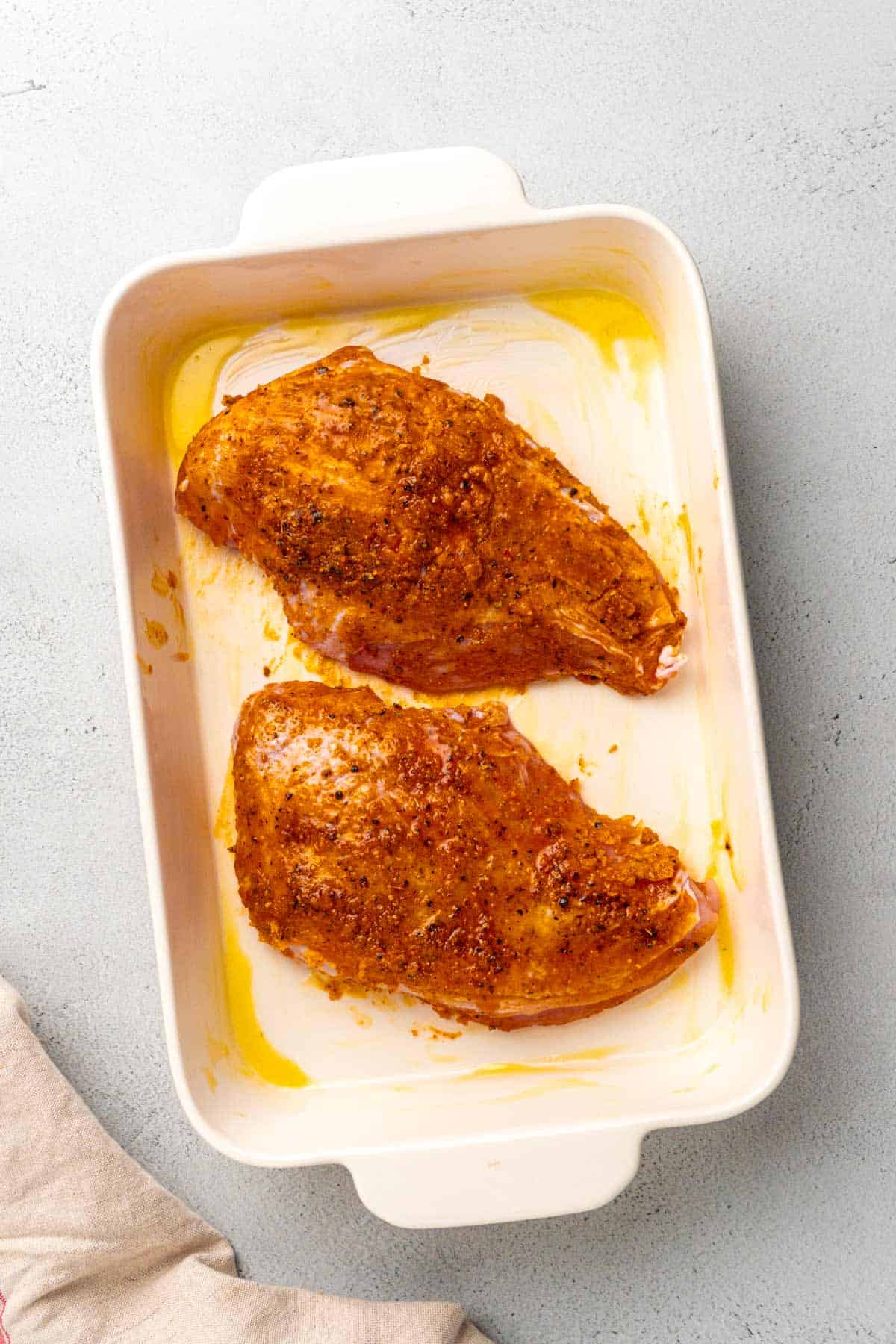 raw seasoned turkey breasts in baking dish.