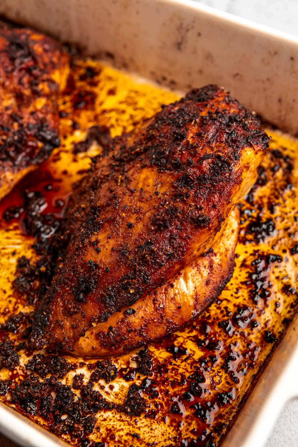 freshly roasted turkey breast in baking pan.
