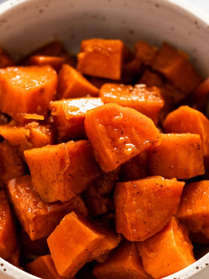 sweet potato cubes in a bowl in sugary syrup.