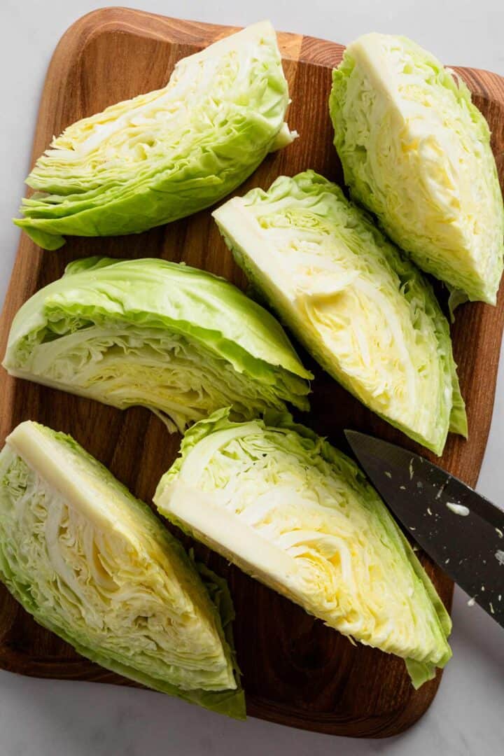 green cabbage head cut into wedges.