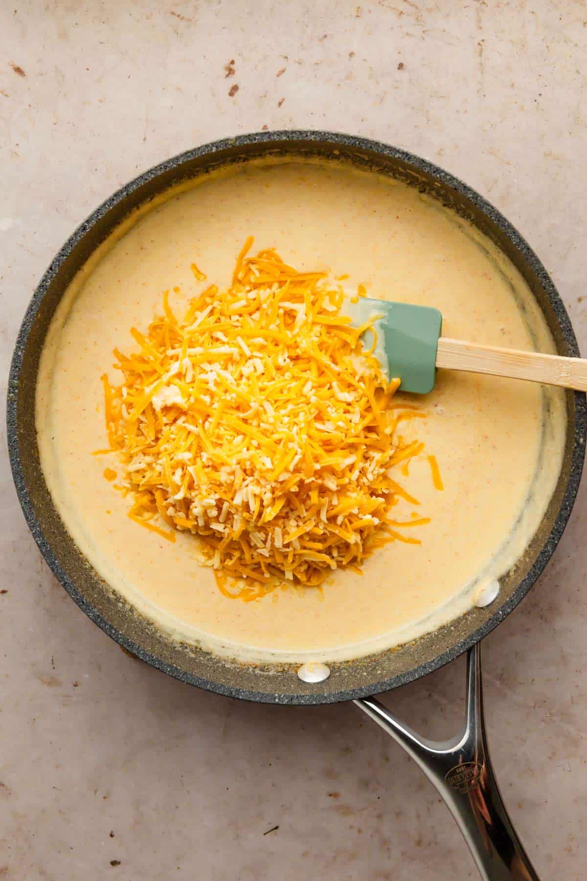 grated cheese added to creamy sauce.
