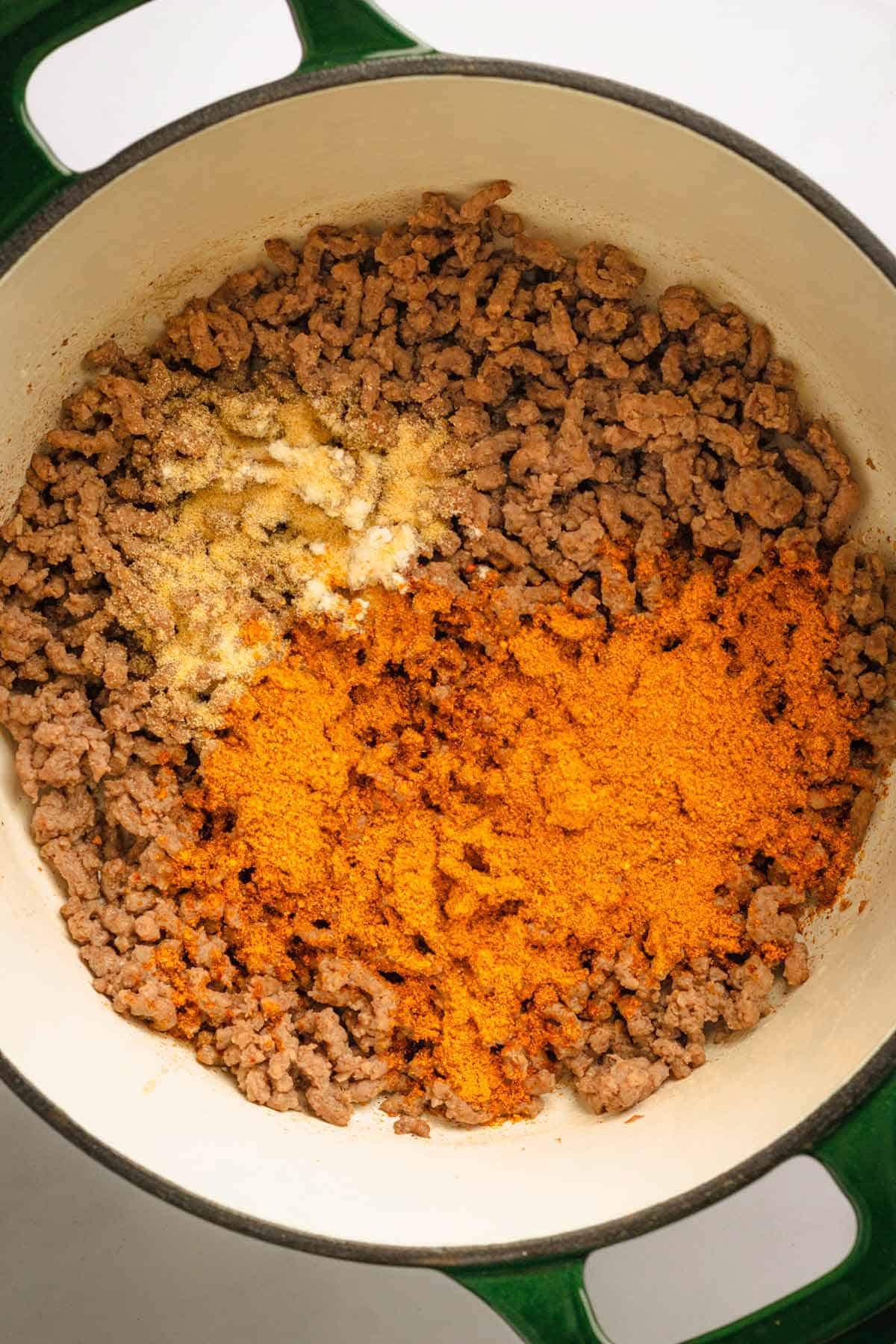 Beef and seasonings in a pot.