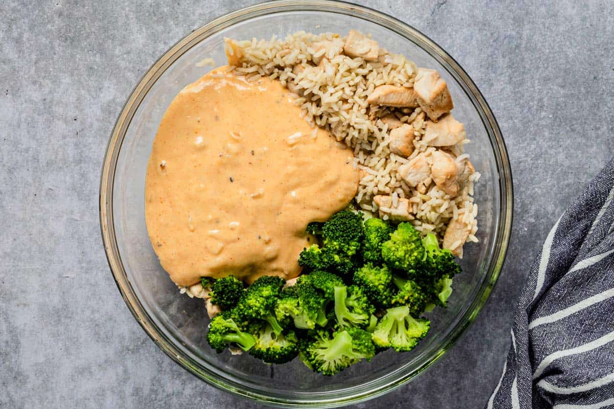 creamy sauce, broccoli and chicken in a bowl before adding in baking dish