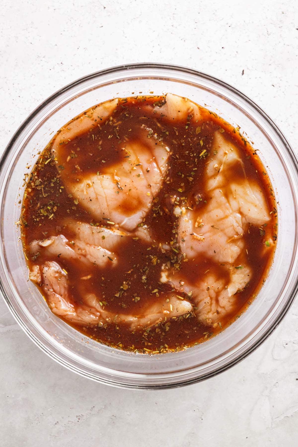 chicken pieces in dark marinade.