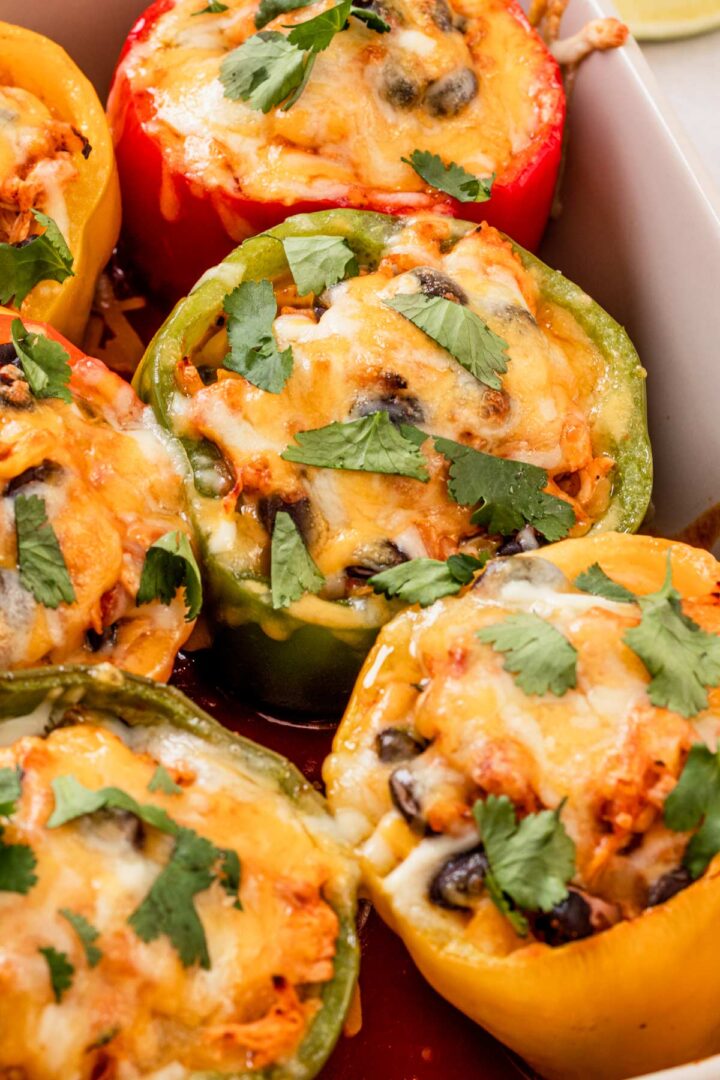baked stuffed peppers with cilantro in a baking dish