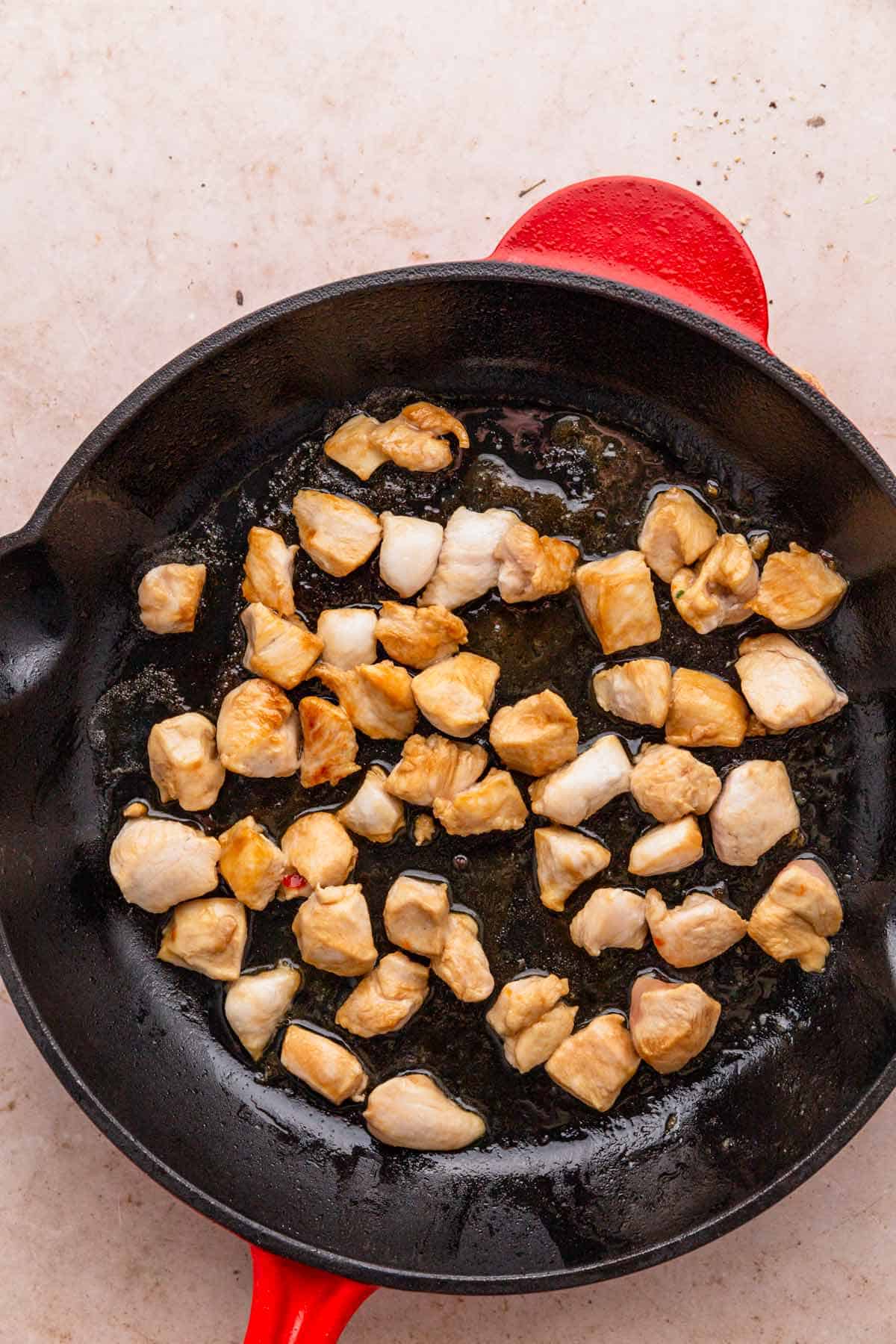 chicken pieces in skillet.