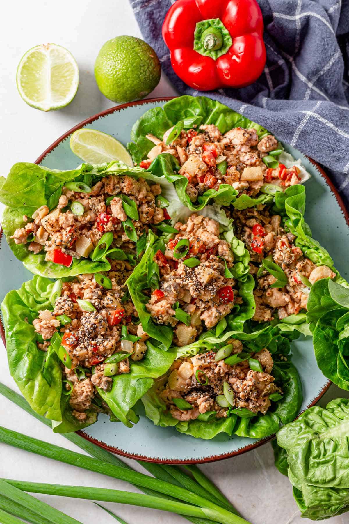 picture of chicken lettuce wraps stacked together on a blue plate