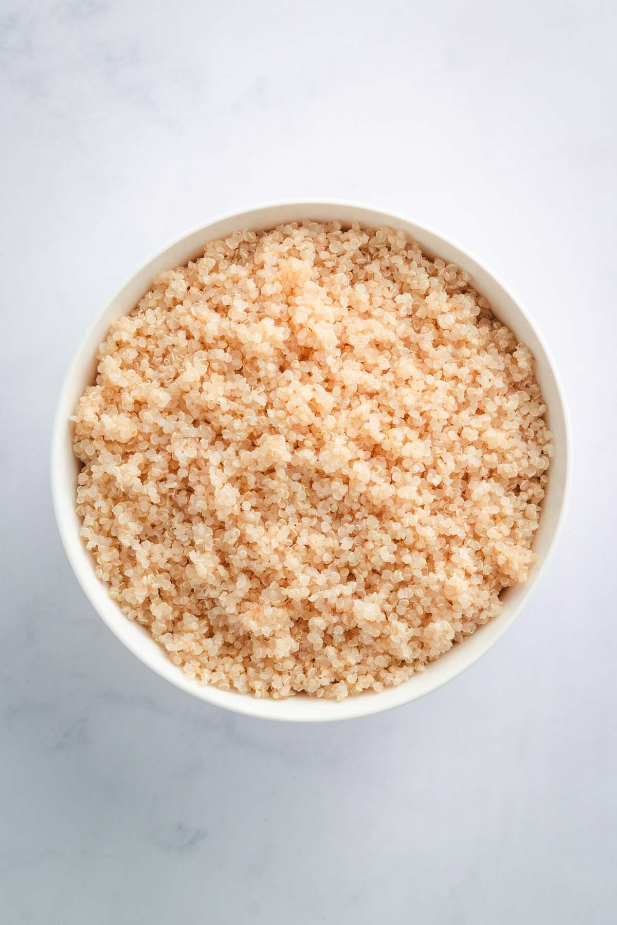 Bowl of cooked fluffy quinoa.