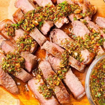 Steak slices topped with Chimichurri sauce.