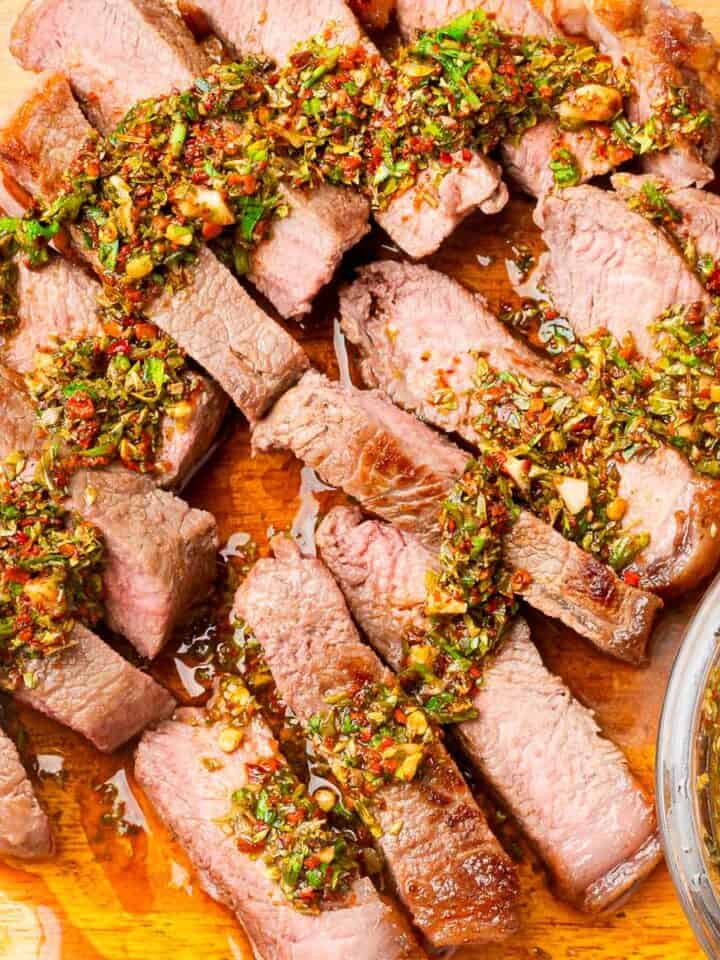 Steak slices topped with Chimichurri sauce.