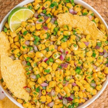 Corn salsa inspired by Chipotle served as a fresh dip with tortilla chips, overhead view.
