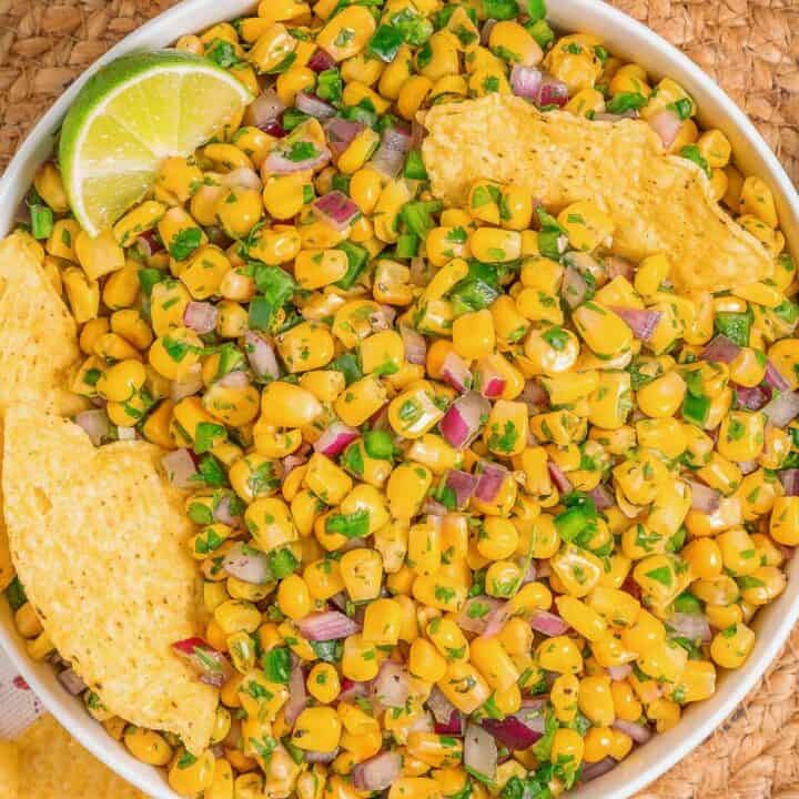 Corn salsa inspired by Chipotle served as a fresh dip with tortilla chips, overhead view.