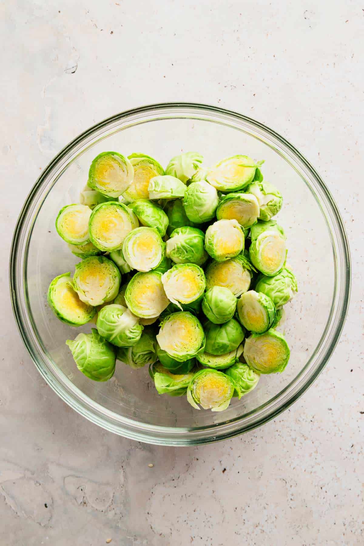 a bowl of halved brussel sprouts.