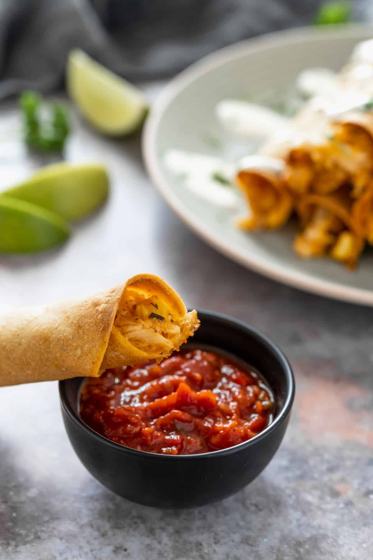 creamy chicken taquitos dipped in red salsa
