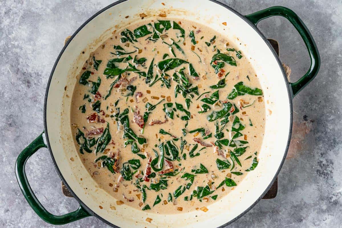 Chicken breasts in an irresistible creamy sun dried tomato sauce filled with spinach, delicious smoked paprika, parmesan, and topped up with salty crispy bacon is definitely a winner of a chicken dinner! - The Yummy Bowl