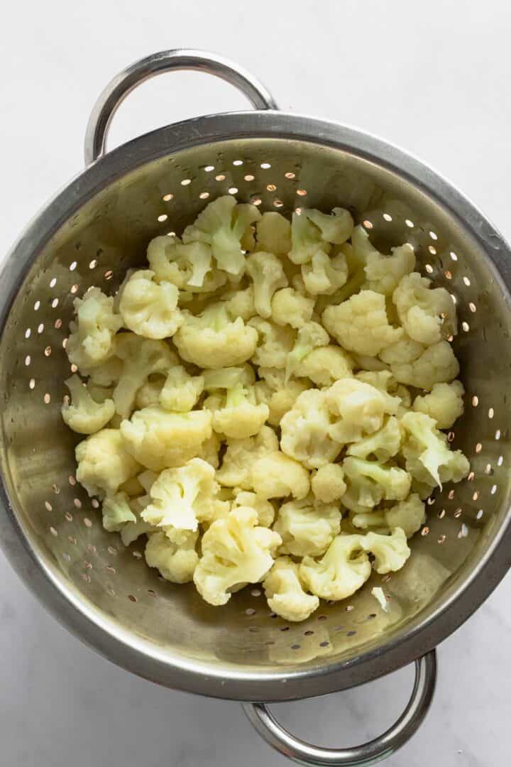 draining cauliflower florets in colander.