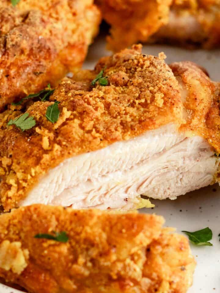 crispy skin sliced chicken thighs on a plate.
