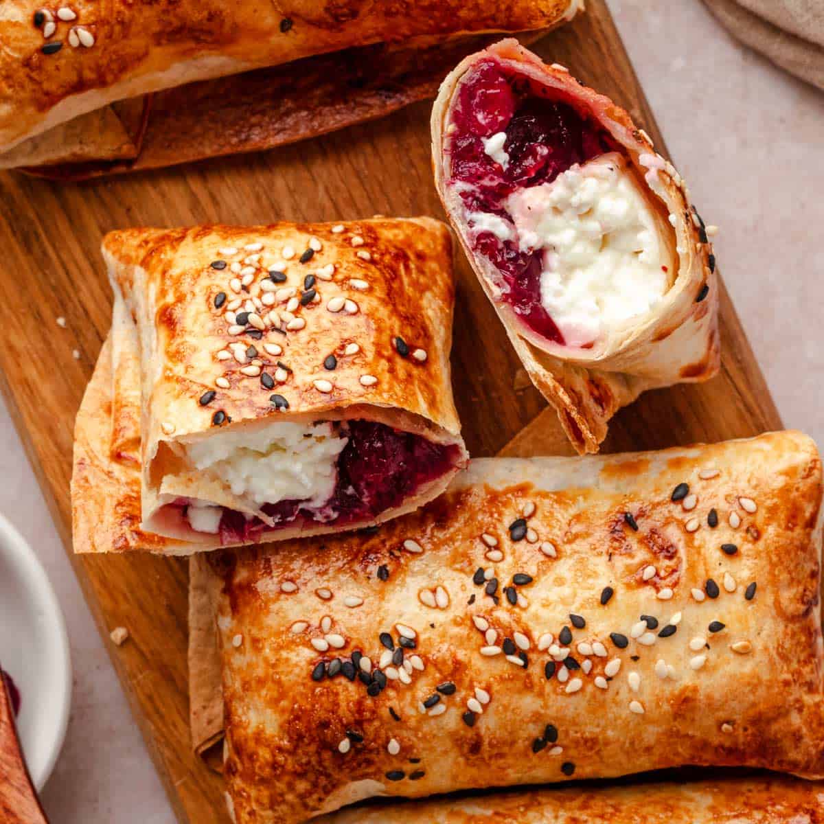 Made in air fryer Crispy feta rolls with cranberry sauce and sesame seeds.