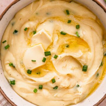 crock pot mashed potatoes in a bowl with green onions