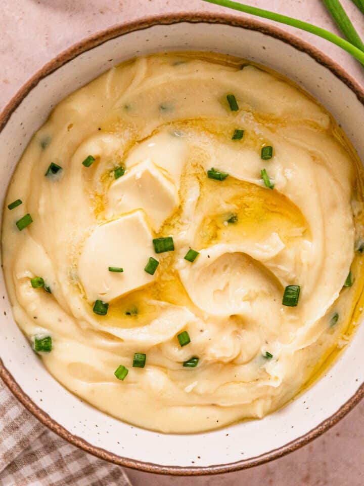 crock pot mashed potatoes in a bowl with green onions