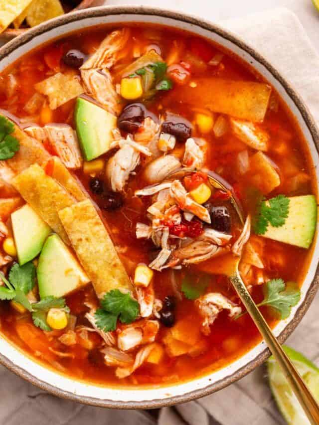 chicken tortilla soup with toppings in a bowl.