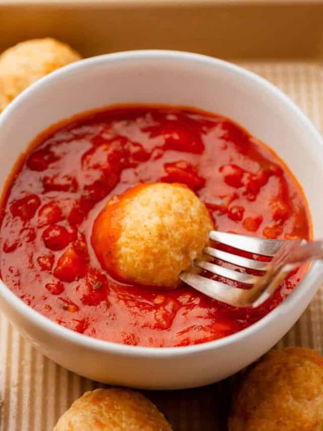 Golden brown ground chicken meatballs with marinara sauce.