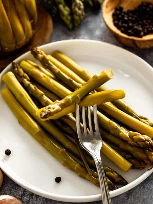 pickled asparagus spears on a plate.