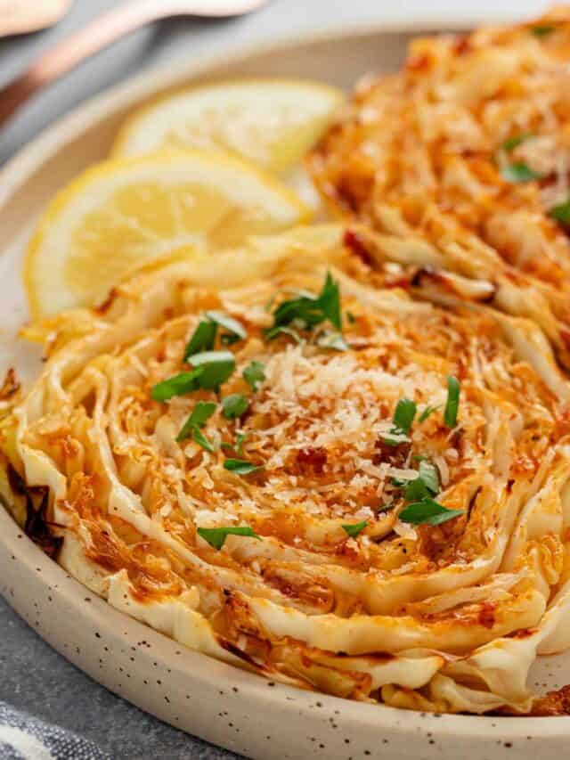 cabbage steaks with freshly grated parmesan and lime slices