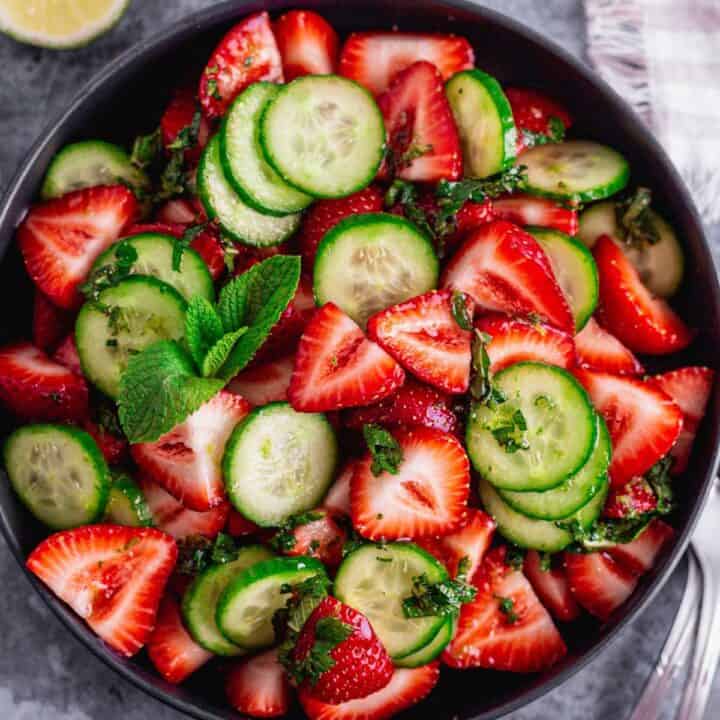 Cucumber Strawberry Salad in a black bowl.