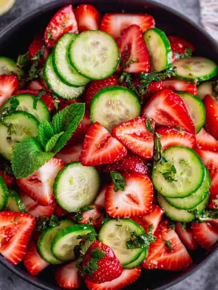Cucumber Strawberry Salad in a black bowl.