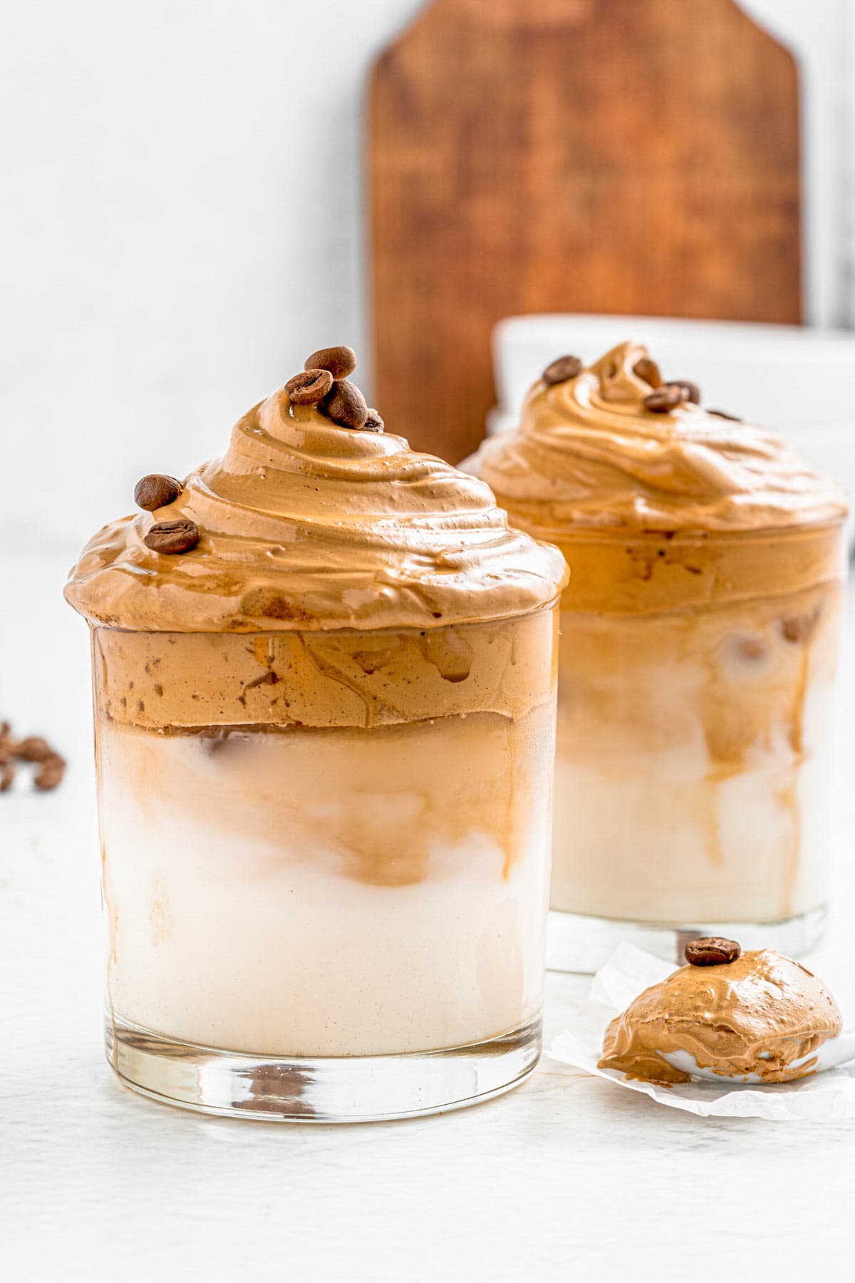 This Dalgona Whipped Iced Coffee recipe calls for four simple ingredients to make the best homemade iced coffee drink. Indulge yourself in the most delicious iced drink with fluffy clouds of whipped coffee over milk. An easy, creamy and superb refreshing drink to enjoy this summer. It only takes about 5 minutes to whip up! #whippedcoffee #dalgonacoffee #icedcoffee #frappe #icedlatte #vegan- The Yummy Bowl