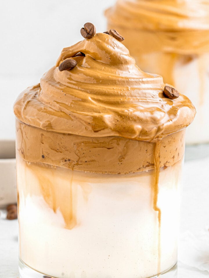 whipped instant coffee and milk in a glass mug.