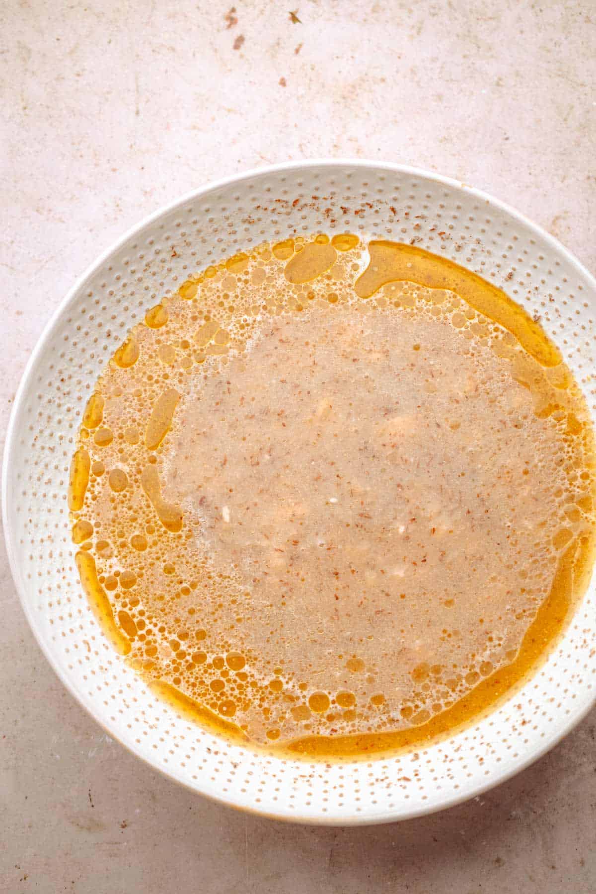 Wet ingredients mixed in a bowl for baked oatmeal.