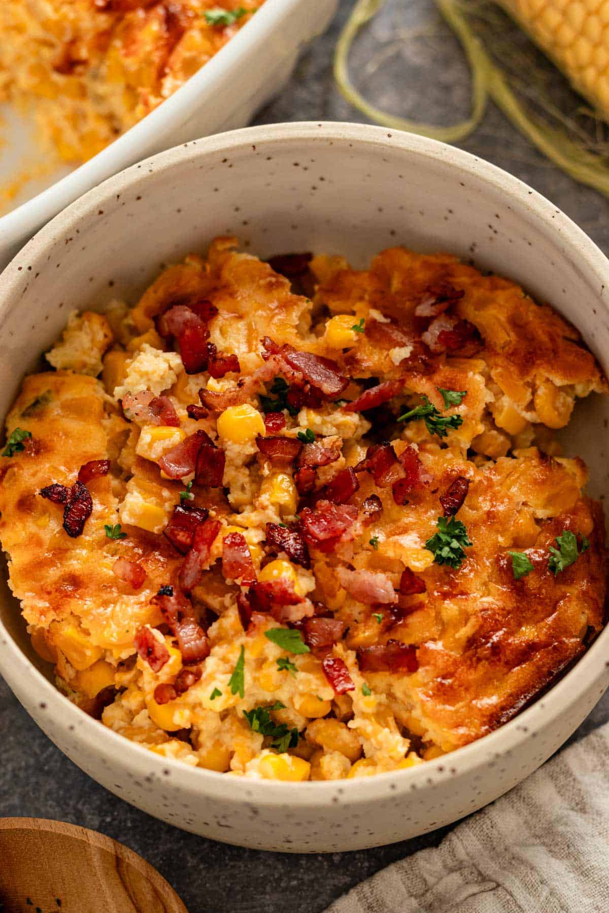 corn casserole with bacon in a bowl.