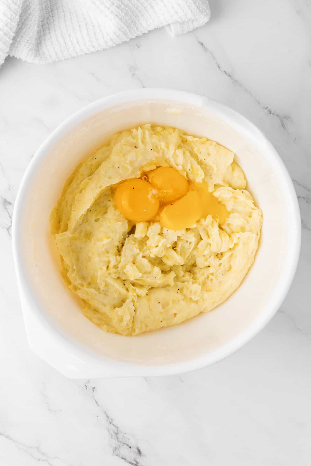 egg yolks added to mashed potato bowl