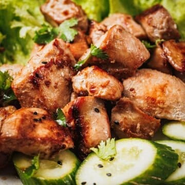 Cooked lemongrass chicken bites with golden edges and fresh herbs.