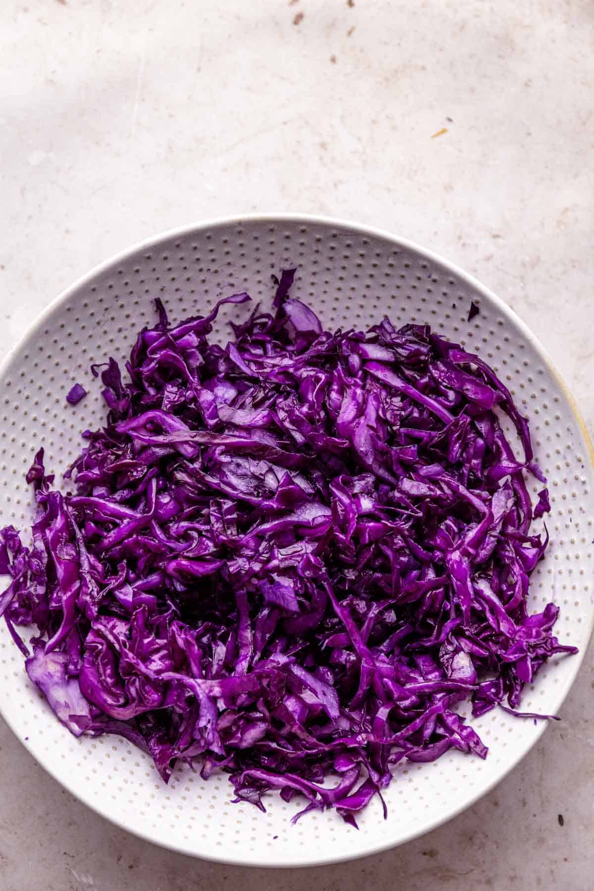 shredded cabbage in a bowl with salt.