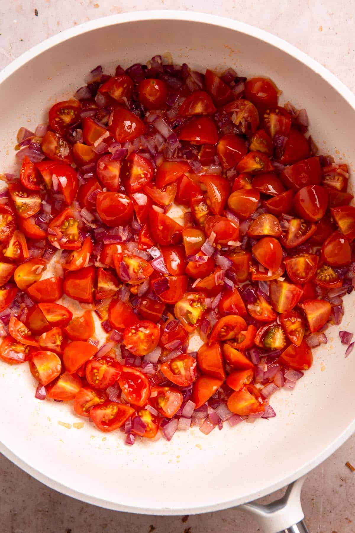tomatoes and onion in skillet.