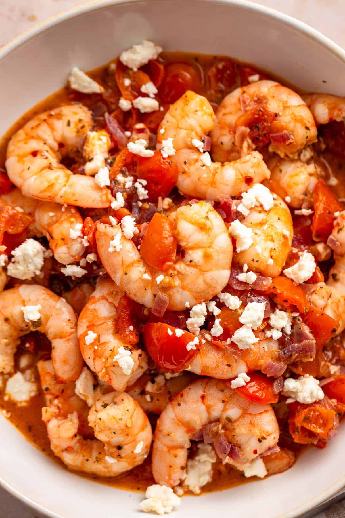 a bowl of sauteed shrimp with tomatoes.
