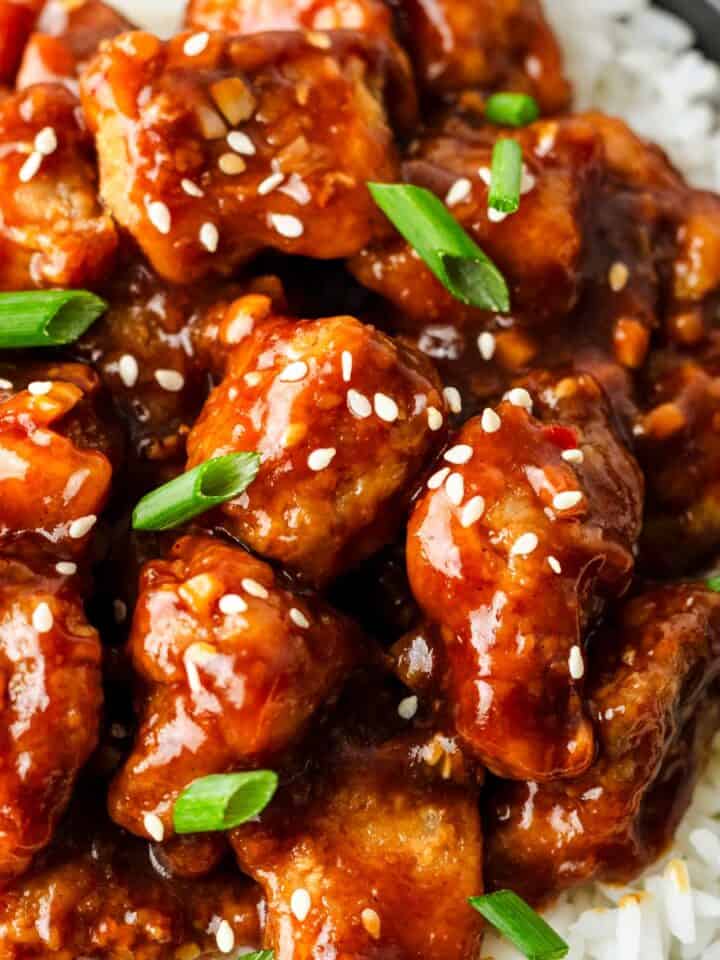 General tso chicken with rice and spring onions.